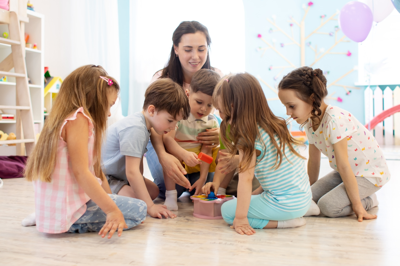 Eine Spielgruppenleiterin betreut kleine Kinder